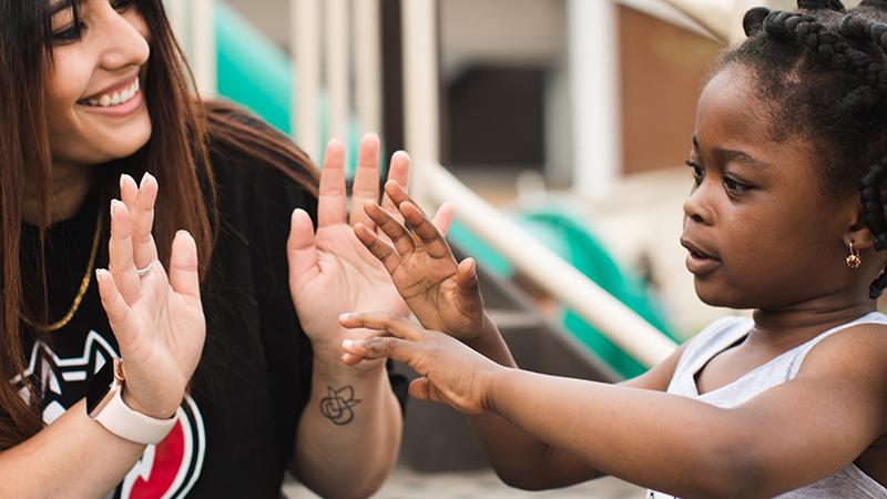 Adult and child hands together