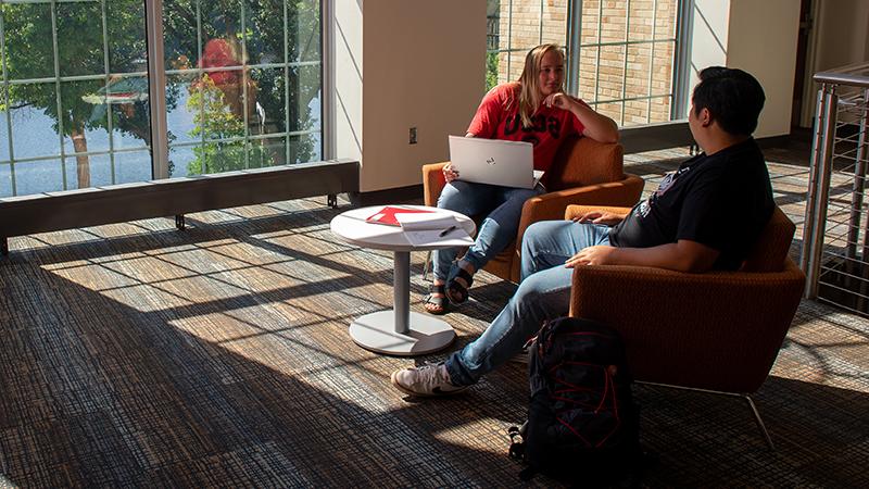 Students talking in Eastman lounge